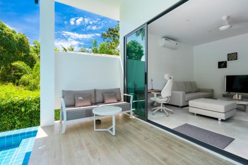a living room with a couch and a table at Bougain Villas in Salad Beach