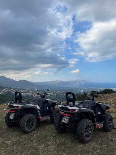 two atvs parked on top of a hill at Arbutus - Relaxing apartment with Fantastic Views in Georgioupolis