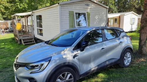 a small car parked in front of a house at Le Ried Camping To hapi in Boofzheim