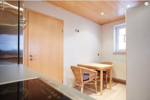 a kitchen with a table and chairs in a room at Ferienwohnung Tannen-Apotheke Zwei in Mengerskirchen