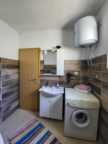 a bathroom with a washing machine and a sink at Nera-etwa Konjic 2 room in Konjic