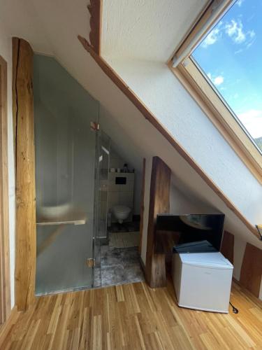 a attic room with a toilet and a window at Turistična kmetija Grabnar in Bled