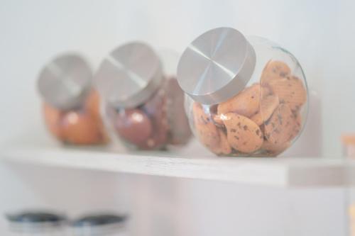 a shelf with four containers of food on it at Nùe Rooms in Cagliari