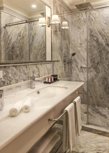 a bathroom with a sink and a shower at Nevv Bosphorus Hotel in Istanbul