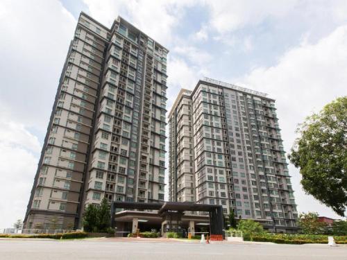 two tall buildings with a building in front of it at A place of peace shaftsbury residence cyberjaya in Cyberjaya