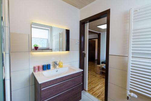 La salle de bains est pourvue d'un lavabo et d'un miroir. dans l'établissement Ferienwohnung Bergblick, à Cochem