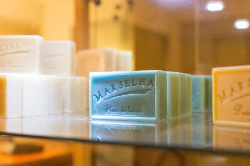 a pile of soap sitting on a glass shelf at Europe Hotel Vieux Port in Marseille