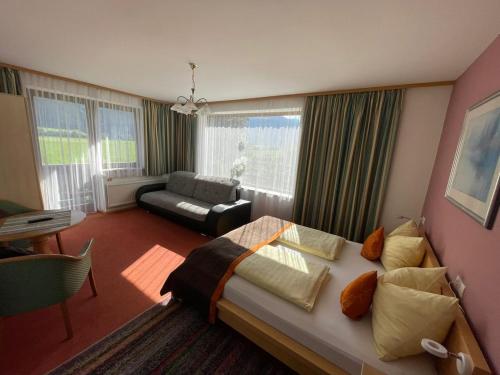 a bedroom with a bed and a living room at Appartment Sonnenschein in Uttendorf