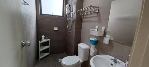 a small bathroom with a toilet and a sink at Modern Lifestyle ARC Austin Hills in Johor Bahru