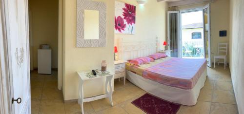 a bedroom with a bed and a table and a window at Luigi Apartments&Rooms in Pula