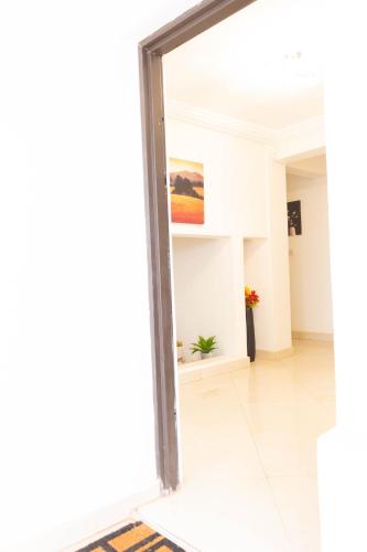 a mirror in the hallway of a building at Lovely 4 Bedroom Solar Powered House with CCTV and Unlimited WiFi near Devtraco Court Community 25 Tema in Tema