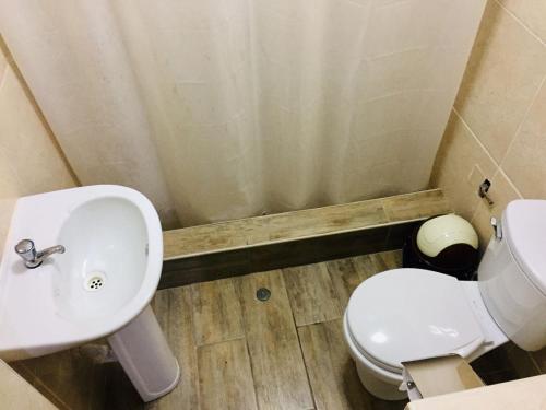a bathroom with a sink and a toilet at KORICANCHA in Lima
