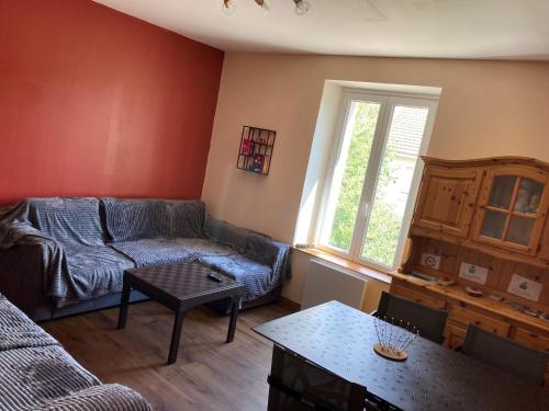 un salon avec un canapé et une table dans l'établissement La trinite, à Gérardmer