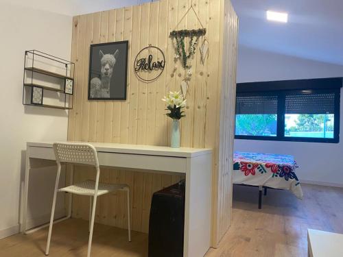 a room with a desk with a chair and a bed at Agradable adosado con zona de aparcamiento in Sedaví