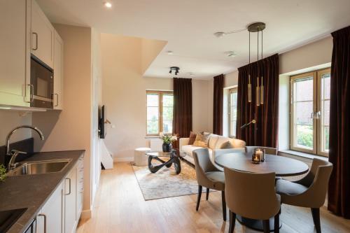 a kitchen and living room with a table and a couch at Live and Stay Ekmanska in Gothenburg