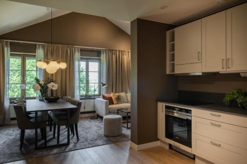 a kitchen and dining room with a table and a living room at Live and Stay Ekmanska in Gothenburg