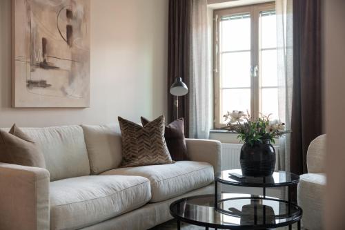 a living room with a couch and a table at Live and Stay Ekmanska in Gothenburg