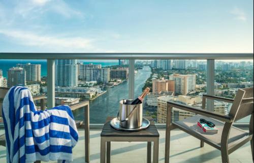 a bottle of wine on a table on a balcony at Relaxing BeachWalk Getaway Studio for 4 Guests 405B in Hallandale Beach