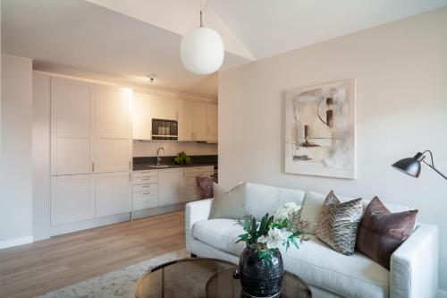 a living room with a couch and a table at Live and Stay Ekmanska in Gothenburg
