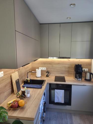 a kitchen with a counter with fruit on it at Modern studio apartment near the beach - 5 min walk in Liepāja