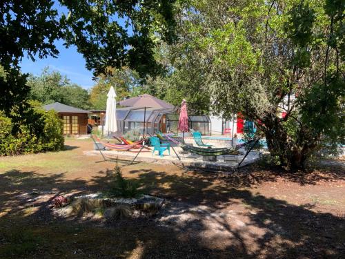 a group of hammocks sitting under a tree at Domaine de Labelo in Commensacq