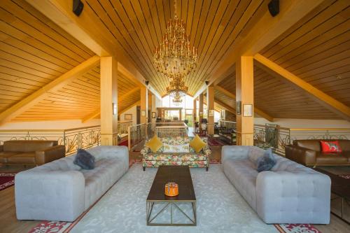 a large living room with couches and a chandelier at Le Palais des Cerisiers in Azrou