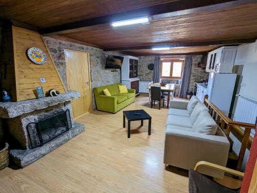 a living room with a couch and a fireplace at Casas do Pastor in Seia