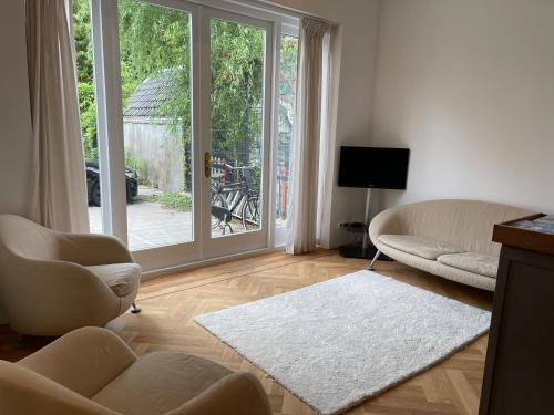 a living room with a large sliding glass door at Canal House in Historic City Center Gouda in Gouda