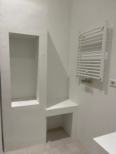 a white wall with shelves in a room at Canal House in Historic City Center Gouda in Gouda