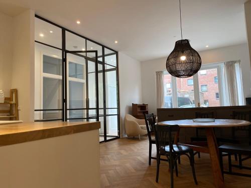 a kitchen and dining room with a table and chairs at Canal House in Historic City Center Gouda in Gouda