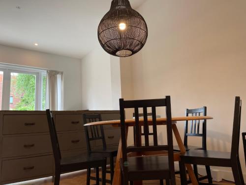 a dining room with a table and chairs and a chandelier at Canal House in Historic City Center Gouda in Gouda