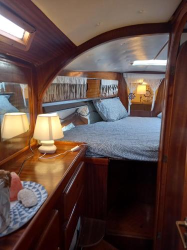 a bedroom with a bed and a table with a lamp at La tua stanza a vela sul mare in Bari