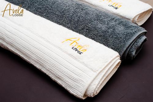 a stack of towels sitting on a table at Avela Lodge in Hekpoort
