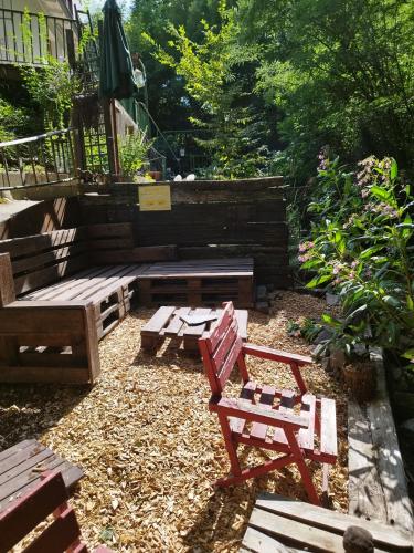 a backyard with benches and a table and a bench at Schmökermühle in Andernach