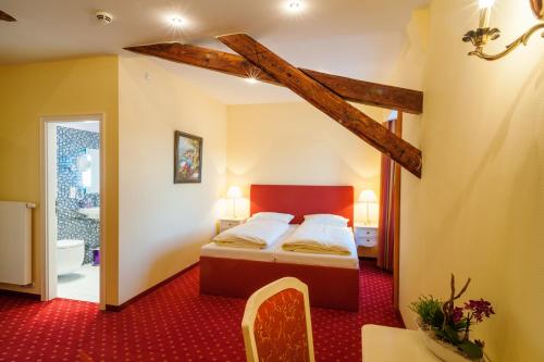 a bedroom with a bed and a red carpet at Quartier Rautenstock GbR in Doberlug-Kirchhain