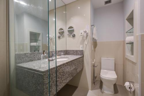 a bathroom with a sink and a toilet at Bourbon Cambará Hotel in Cambará