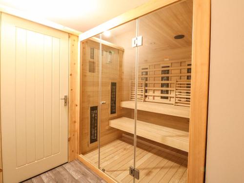 a sauna with a glass door and a walk in shower at Luxury Highland Home in Scotlands' Great Glen in Gairlochy
