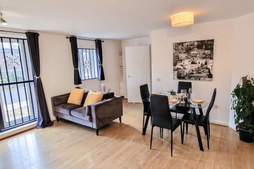 a living room with a couch and a table at Comfy 2 bed Flat with free Parking, close to Tube in Woolwich