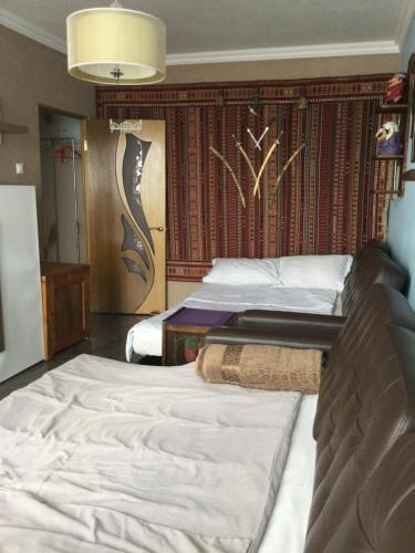 a bedroom with two beds and a wall at Apartment Na Lidzava Beach in Pizunda