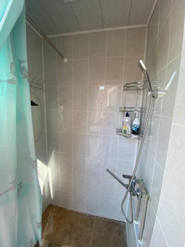 a bathroom with a shower with a shower head at Naryn Guest House in Naryn