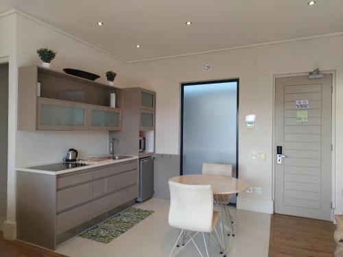 a kitchen with a table and a counter top at The Rex Studio Apartment in Knysna