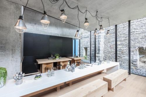 a dining room with a long table and some lights at Jacob’s Getaway in Ghent