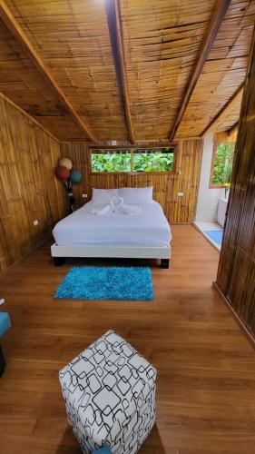 a bedroom with a bed in a room at Mindo GlamBird Glamping & Lodge in Mindo