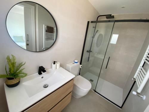 a bathroom with a white sink and a mirror at Villa Casa Blanca in Blanes