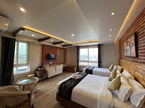 a bedroom with a large bed and a brick wall at Hotel Kesu Home in Kathmandu