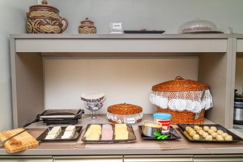 a shelf with food on a counter in a kitchen at Pousada Maanaim Porto in Porto De Galinhas