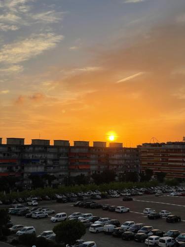 a sunset over a parking lot with cars parked at Apartamento Paradis Playa in La Pineda