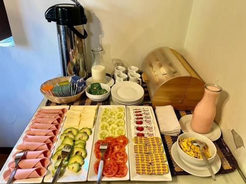a table with many different types of food on it at Lodge El Portal de Qopuy in Coporaque
