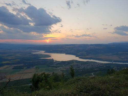 a view of a river at sunset from a mountain at Mondeus Inn Luxury in Deskáti