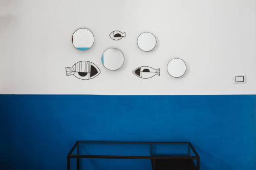 a wall with several mirrors on a blue wall at Casa aMmare in Pioppi